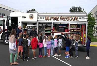  Jamison students talking with firefighers in front of a firetruck